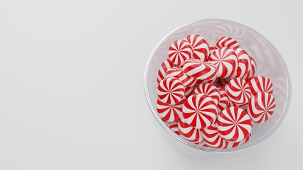Christmas Peppermint Swirls on Glass Pot on White Background.
