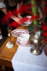 woman is waiting for guests and sets the table. festive laying table, preparation for christmas dinner.
