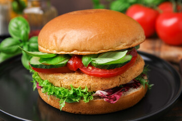 Delicious vegan burger with chickpea cutlet on wooden table, closeup