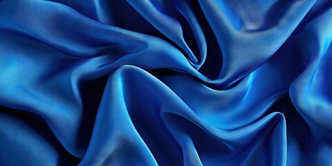 Fototapeta premium Blue silk fabric, abstract background featuring cerulean silk. Draped fabric texture. Copy space. Design element. Valentine's Day. Textural pattern, ornament, background.
