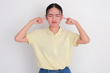 A women close her ears with finger showing annoyed expression