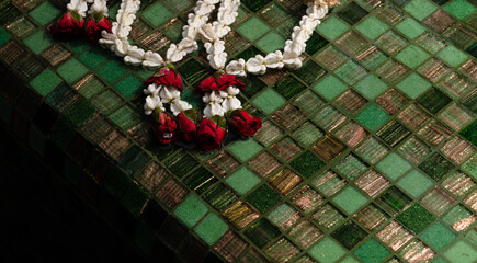 Handmade bracelet of fresh tropical flowers in pool