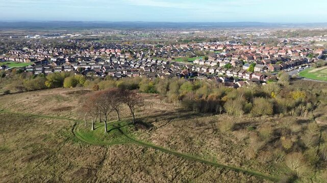 Aerial of housing estate with Seven Sister ancient memorial in foreground. Houghton-le-Spring, UK
