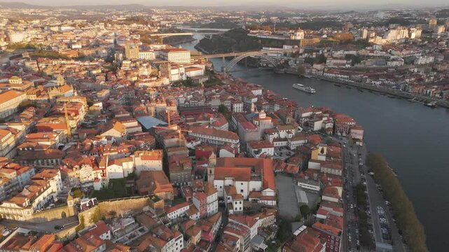 Soar over the enchanting Douro River between Porto and Vila Nova de Gaia! This stuniing aerial view showcases Portugal's iconic river, historic bridges, adn picturesque cityscapes on both sides.