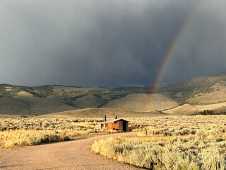 Rainbow over mountains with a storm in the background 