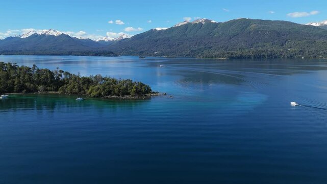 aerial view of Lynch Bay in the Arrayanes Forest, located within Nahuel Huapi Lake in Patagonia, Argentina. The pristine blue waters contrast with the lush green forest.