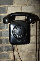 Medemblik, Netherlands. February 28, 2024. Old bakelite telephone against a wall.
