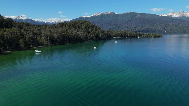 Lynch Bay in the Arrayanes Forest, located within Nahuel Huapi Lake in Patagonia, Argentina. The pristine blue waters contrast with the lush green forest