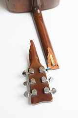part of broken wood acoustic guitar isolated on white background