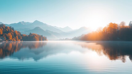 Tranquil morning view of serene lake surrounded by mountains and trees