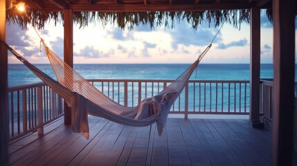 A casual striped dress hangs on a hammock near a beachside porch, the soft lighting and ocean view leaving room for text