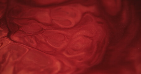Marble spill. Paint fluid. Stone texture of bright enamel with glitter powder overflow. Pouring...