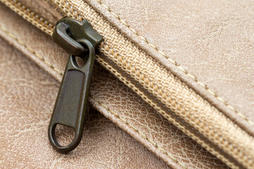 Close-up of the zipper on a leather wallet. Leather with metal zipper © DwiwantoIndrayu
