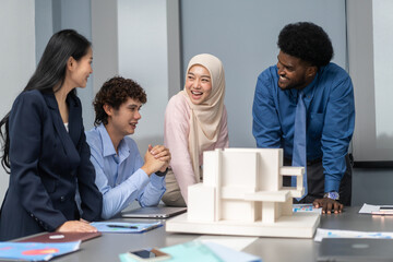 Architects engineers collaborating on building design project in modern office, diverse team of professionals female muslim architect and male engineers discussing architectural model of structure