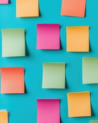 Fototapeta premium A vibrant arrangement of colorful sticky notes on a teal background, showcasing creativity and organization in a playful, engaging manner.