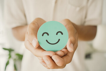 Male Teen holding smile emoji face, positive mental health, world mental health day concept