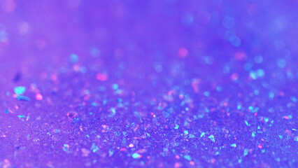Sparkling fluid. Liquid shimmer flow. Blur purple color shiny holographic glitter particles gel emulsion paint gloss spill abstract art background with bokeh lights.
