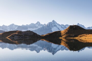 Autumn landscape view of a mountain range reflecting in a lake