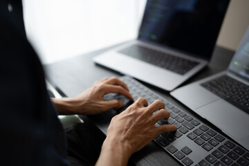 Asian man software engineer Working on Computer at office desk for writing program code IT Software...