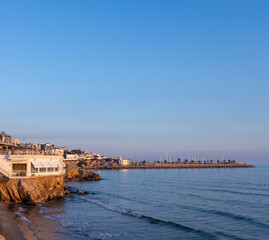 Beautiful beach with a small white building on the shore