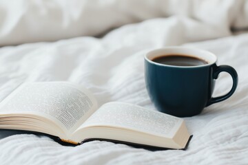 Open book and coffee cup resting on white sheets promoting relaxation and leisure