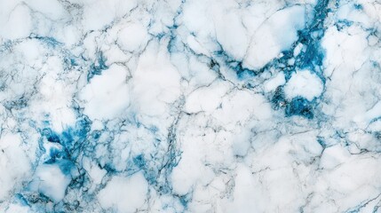 White and blue marbled stone surface with intricate swirling patterns and smooth texture, ideal for backgrounds or design projects.