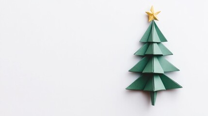 Obraz premium Origami Christmas tree with layered green paper and a gold star on top, positioned on a clean white background for a festive touch.