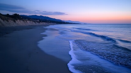 Fototapeta premium Tranquil beach scene at sunset with gentle waves and soft pastel colors.
