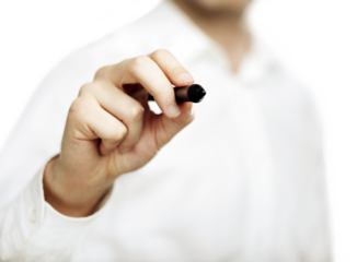 A close-up of a hand holding a pen, pointing forward. The person wears a white shirt, and the background is soft white. Concept of writing
