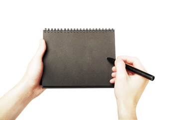 Hands holding a blank spiral notebook and apen, close-up. Isolated on a white background. Concept of writing, sketching, or note-taking