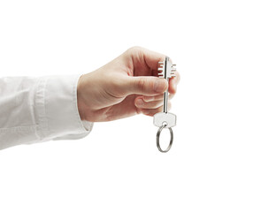 A closeup of a hand in a white shirt holding a house key. The scene is isolated on a white...