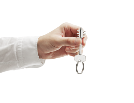 A closeup of a hand in a white shirt holding a house key. The scene is isolated on a white background. Symbolizes new home ownership or real estate