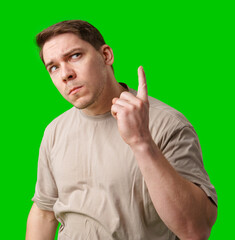 Thoughtful man gestures against a green background