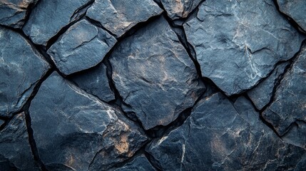 Fototapeta premium Close up of a dark stone wall with irregular shapes.