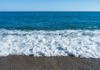 High tide in the mediterranean sea,ripple water with sea foam