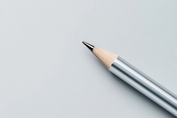 Naklejka premium Sleek Metallic Mechanical Pencil on Light Gray Background