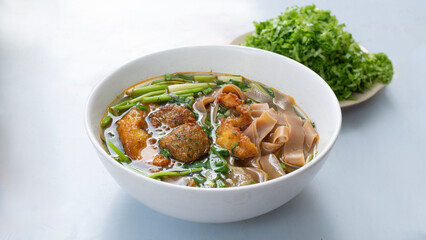 Banh Da Cua rice noodle soup with fish cake. Vietnamese soup containing rice vermicelli and grilled chopped fish. Red Noodle Soup with Crab. Banh da cua nghe an, Hai phong. Vietnam street food.