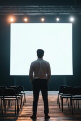 Fototapeta premium Man facing blank screen, empty chairs.