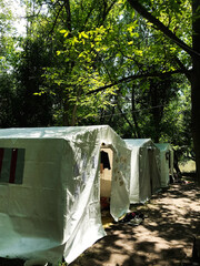 Outdoor camping tents in a lush green forest setting