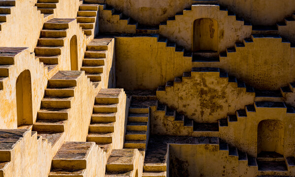 Exploring the ancient architectural pattern of stepwells in india, a symmetrical and intricate design of traditional geometric stairs for water management and historical heritage in rajasthan