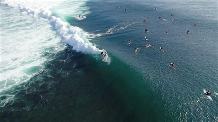 High angle slow motion of passionate water sports surfing in Bali, Indonesia