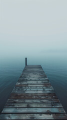 Fototapeta premium A meditative landscape of a mountain lake viewed from a small boat dock with fog in early spring or autumn. Perfect for screensavers or interior design.