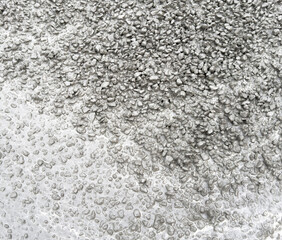 A grey and white background with a lot of small rocks