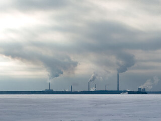 A large industrial area with smoke and steam rising from the factories