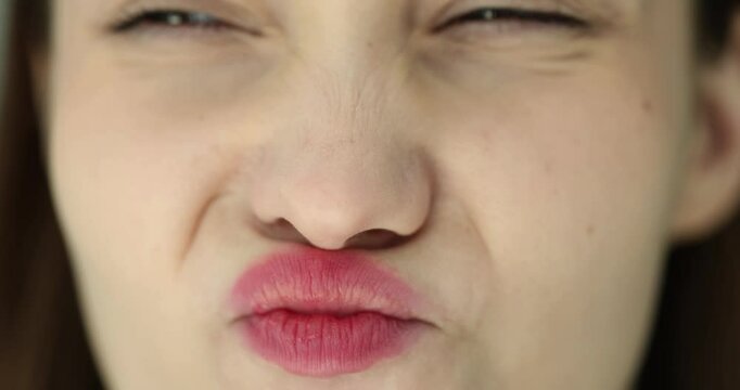 Closeup of woman face during sniffing session or emotions of grimace and displeasure