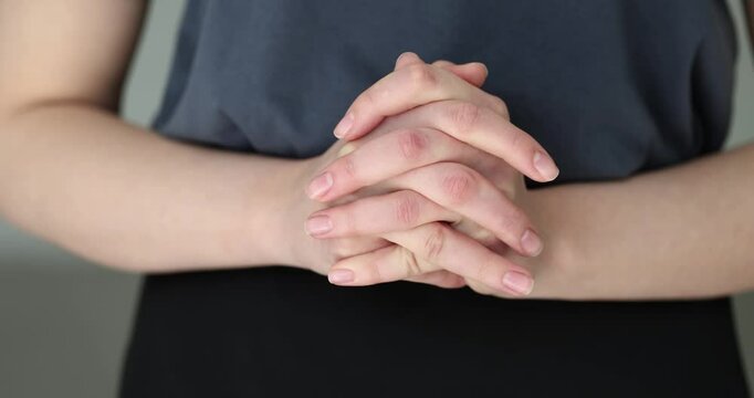 Closeup of woman hands clasped in prayer