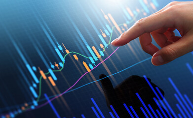 Stock market trading chart and analyzing investment opportunity. Broker touching stock exchange price graphs.