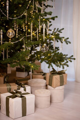 A Christmas tree with a lot of ornaments and boxes of gifts
