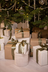 Close-up of many boxes with Christmas presents under a decorated Christmas tree