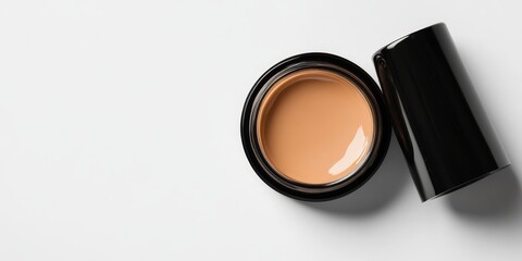 Cosmetic foundation displayed in a close up view, featuring an opened bottle or jar showcasing liquid skin foundation on a white backdrop. Explore the makeup concept of cosmetic foundation, including